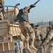 A soldier jumps out of a five-ton truck at the first stop