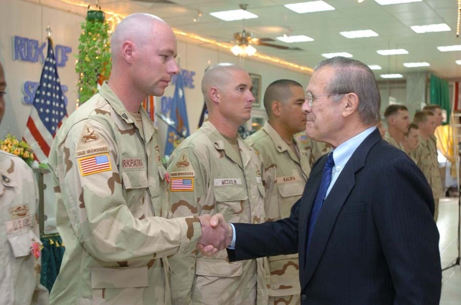 Donald Rumsfeld congratulates Staff Sgt. James Kirkpatrick