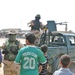 An Iraqi Army Soldier watches over residents of Sadr City