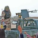 An Iraqi Army Soldier gives bottled water to residents