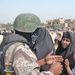 Iraqi Army Soldiers line up residents of Sadr City