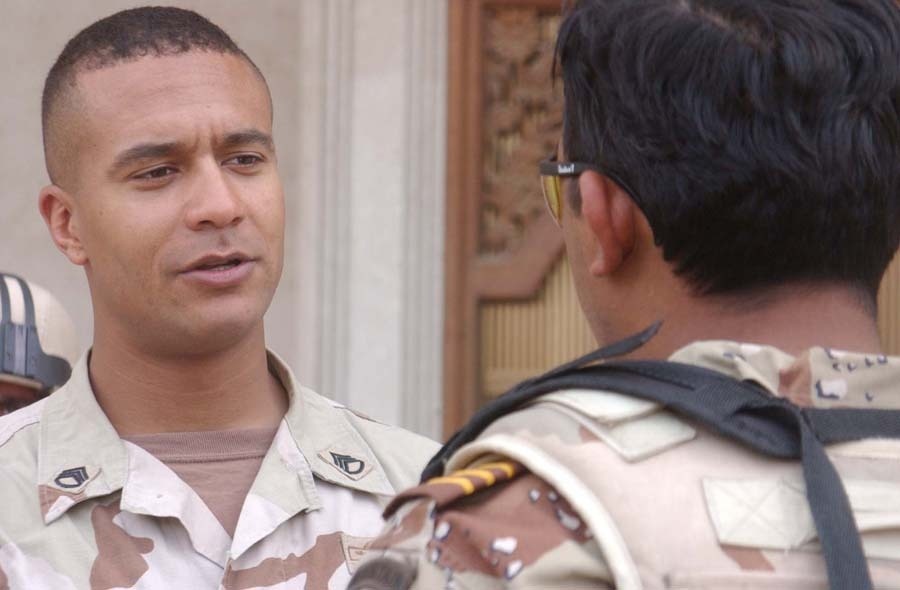 Staff Sgt. Kiplangat D. Marisin speaks to Iraqi Soldier