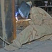 Pfc. Hollenback welds the corner of an armored box