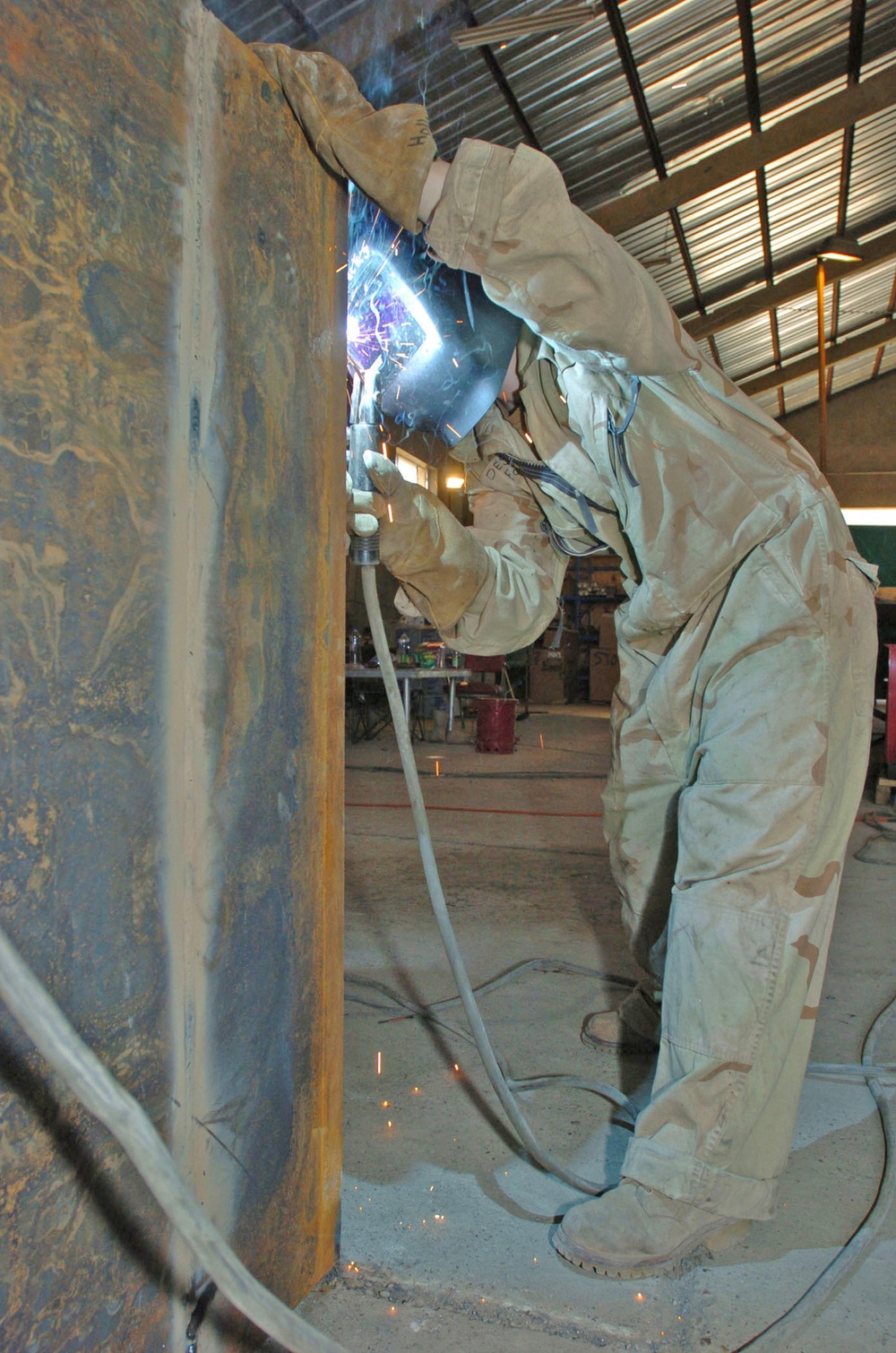 Pfc. Mandaline Hollenback welds an armored box