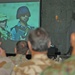 A Japanese Army officer watch a picture slide show