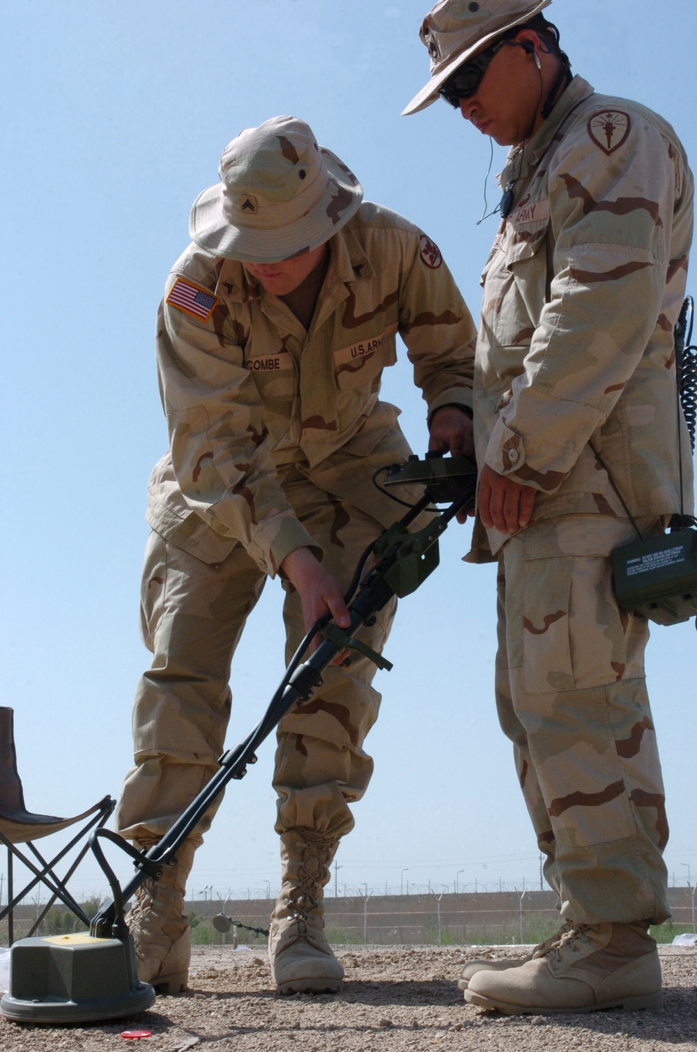 Cpl. James Holcombe helps Staff Sgt. Tony DiCharia