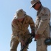 Cpl. James Holcombe helps Staff Sgt. Tony DiCharia