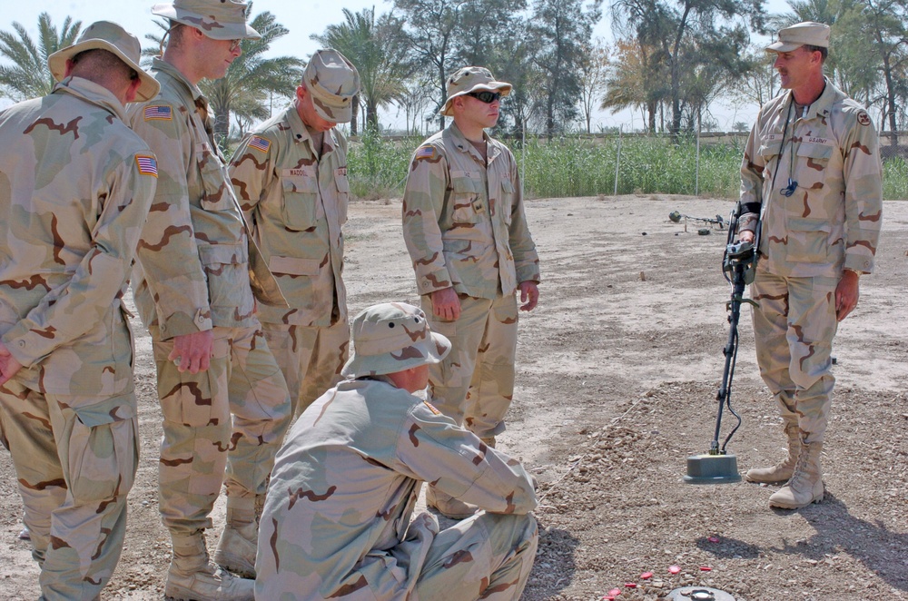 Sgt. Gates demonstrates sweeping techniques to Soldiers