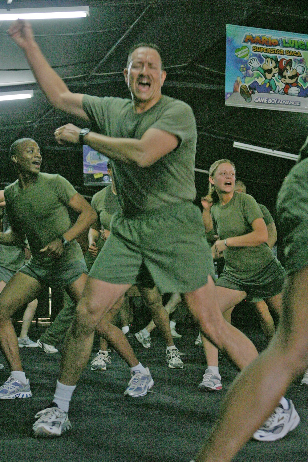 Lt Col. John R. Gambrino counts off while doing aerobics