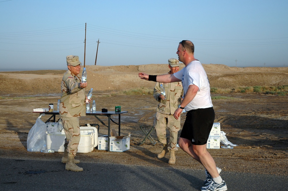 Chaplain (Lt. Col.) David White hands off a bottle of water