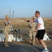 Chaplain (Lt. Col.) David White hands off a bottle of water