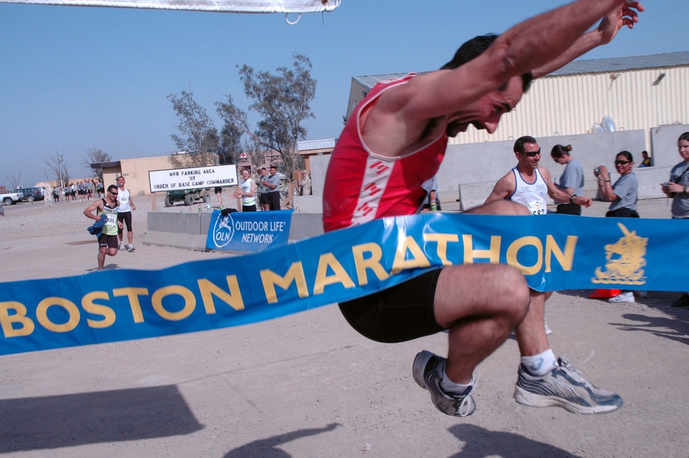 Giovanni Stella jumps through the finish line