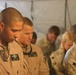 Petty Officer 3rd Class Luis Collazo bows his head