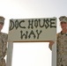 Two Soldiers stand with the road sign dedicated