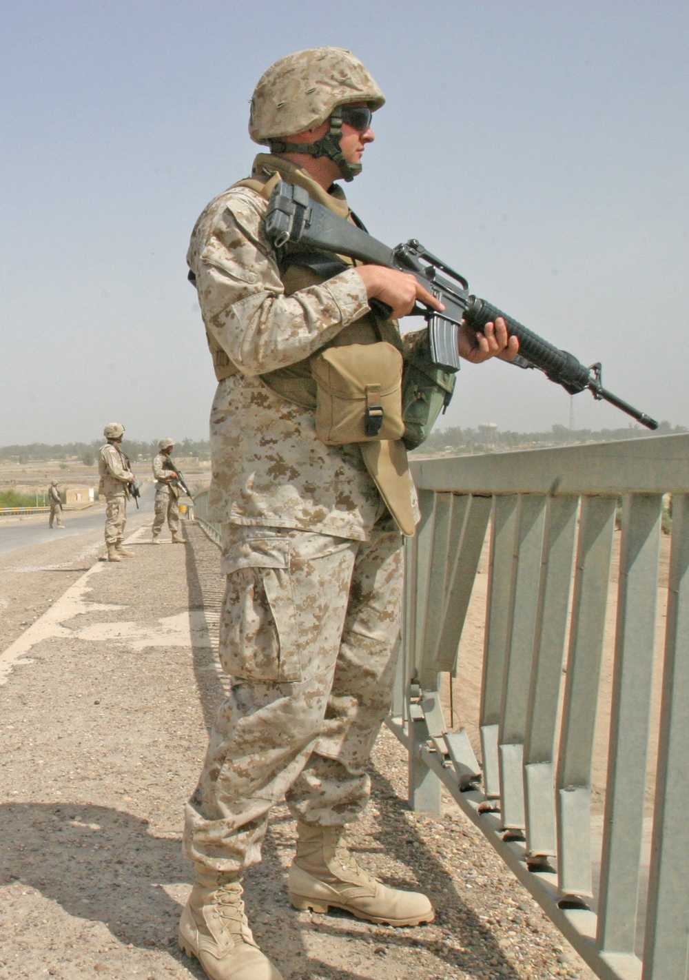 Corporal Dennis Conklin watches traffic from a bridge