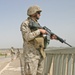 Corporal Dennis Conklin watches traffic from a bridge