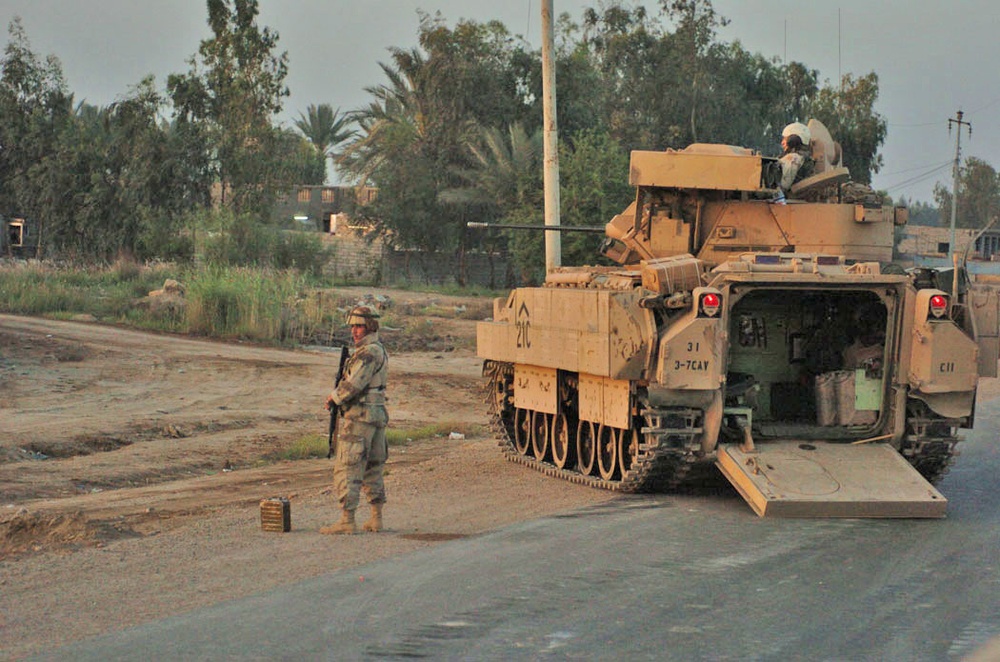 An Iraqi Army Soldier dismounts from a Bradley