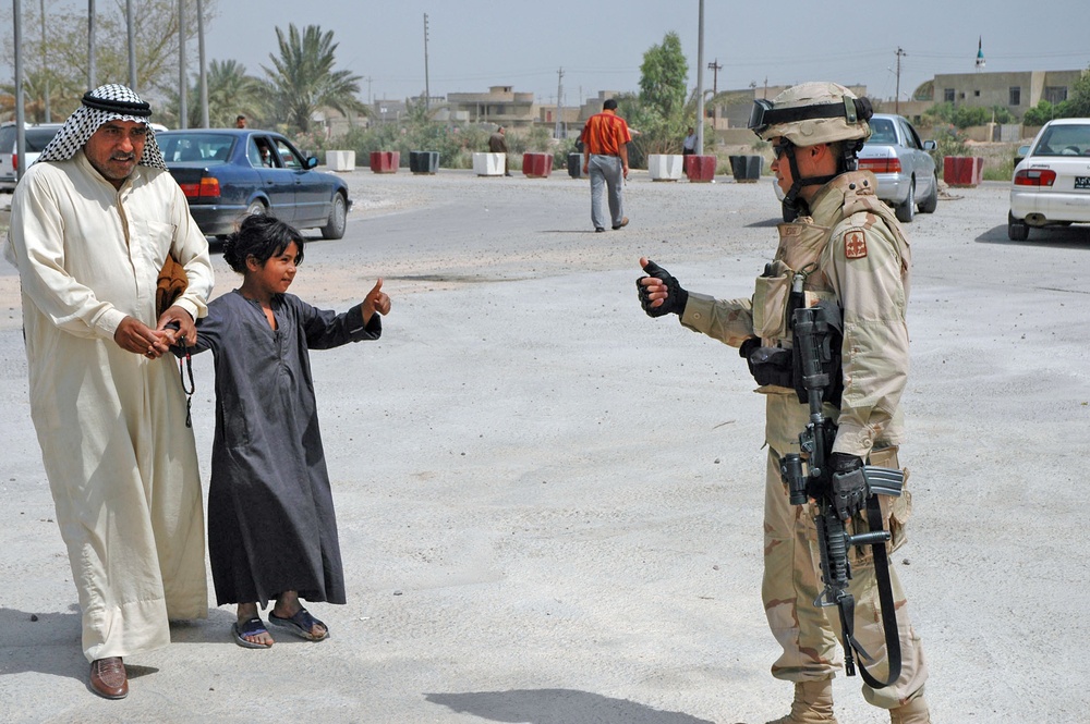 Sgt. Uesug gives the thumbs up to an Iraqi child