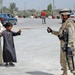 Sgt. Uesug gives the thumbs up to an Iraqi child