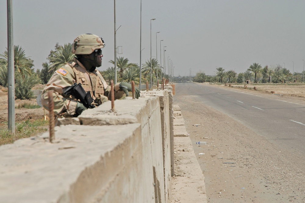 Spc. Jeffrey J. James scans the Baghdad rooftops