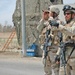 Sgt. Uesugi  points out Iraqi citizens on a rooftop