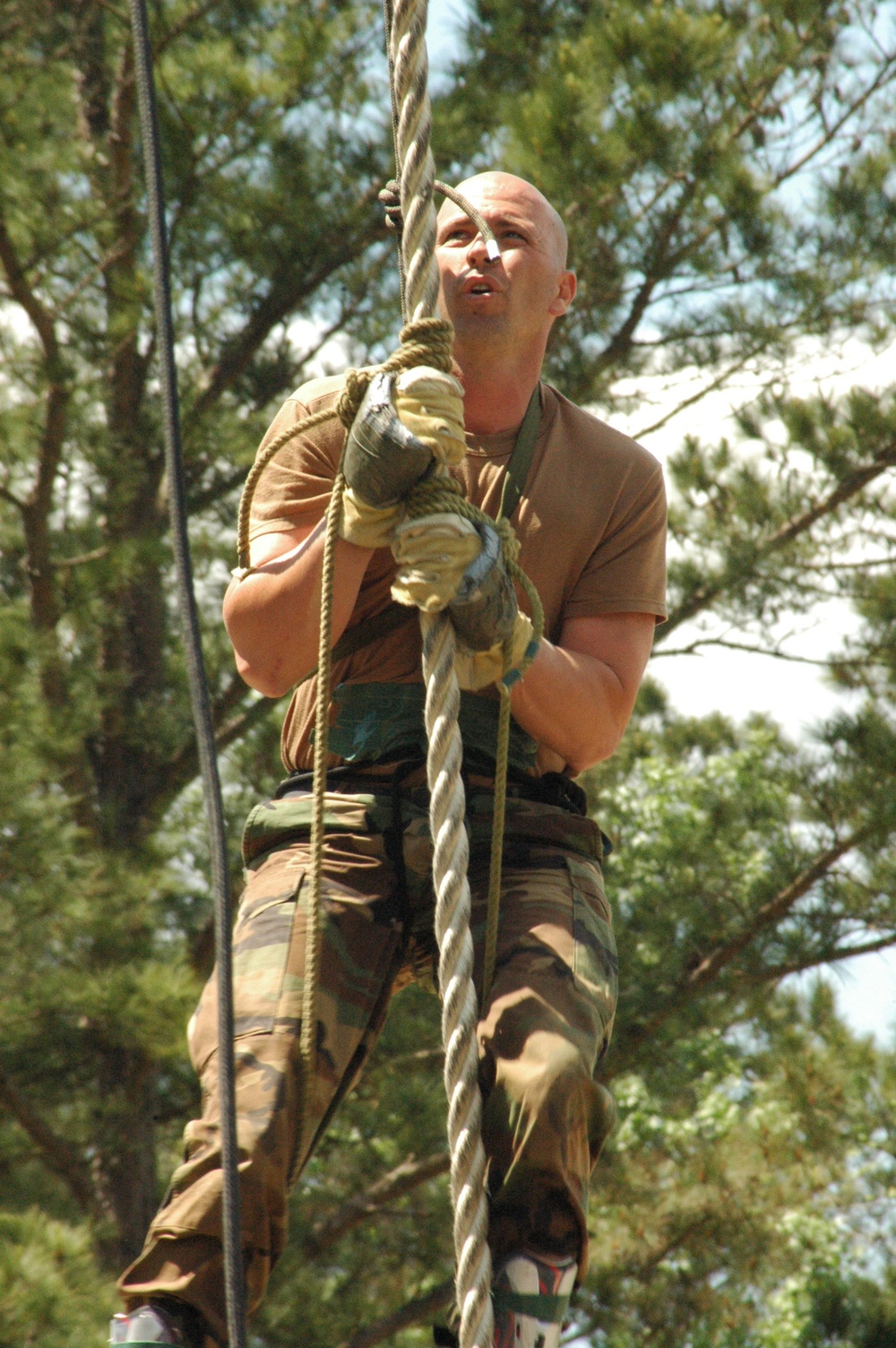 Sgt. 1st Class Gerald Nelson climbs a 90-foot rope