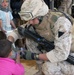 Alberto Reapegur shares water with a young Iraqi child