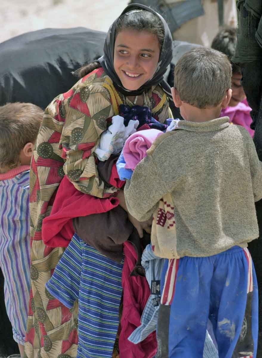A young Iraqi girl looks back at her mother