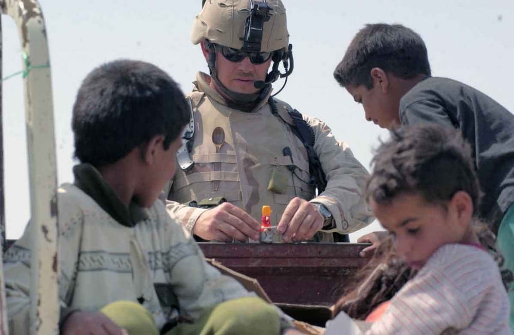 SSgt. Chisum amazes young Iraqi children with a toy