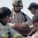 SSgt. Chisum amazes young Iraqi children with a toy