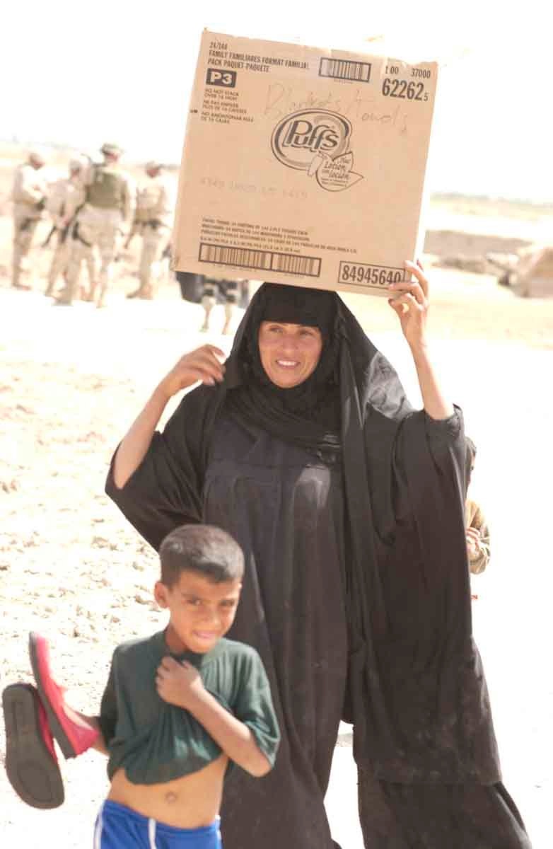 Iraqi mother and child are joyous after receiving blankets