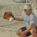 Eddie M. Resinto  prepares to catch the ball behind homeplate