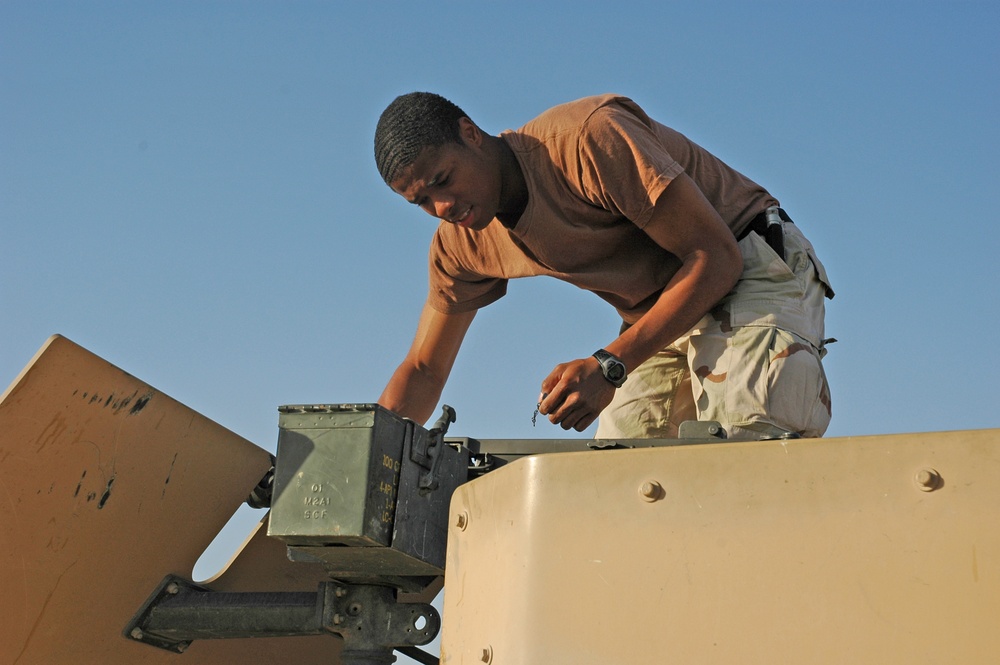 Spc. Jay Groover prepares the .50-calibur machine gun