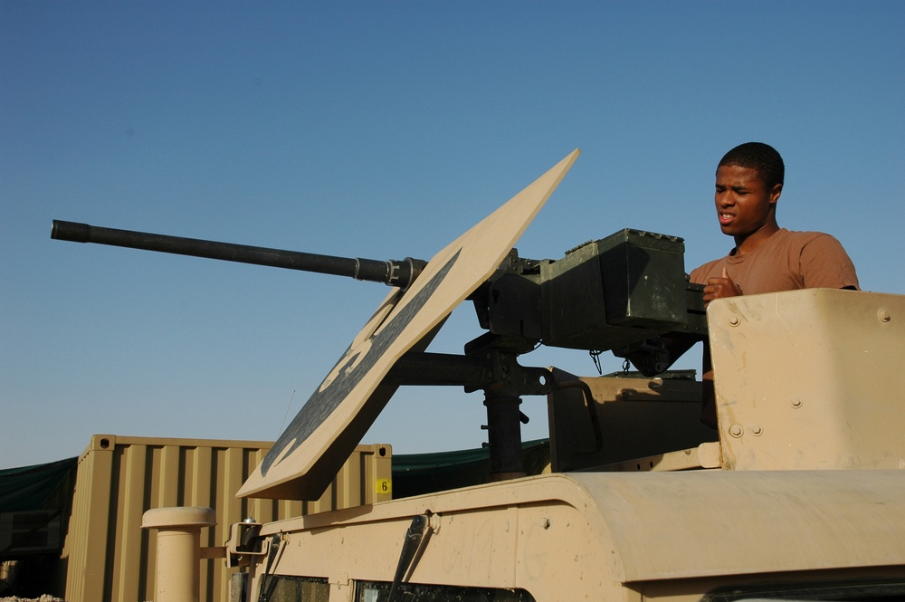 Spc. Jay Groover checks a .50-calibur machine gun