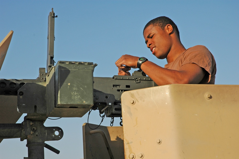 Spc. Jay Groover checks a .50-calibur machine gun