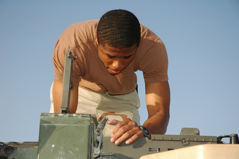 Spc. Jay Groover checks a .50-calibur machine gun