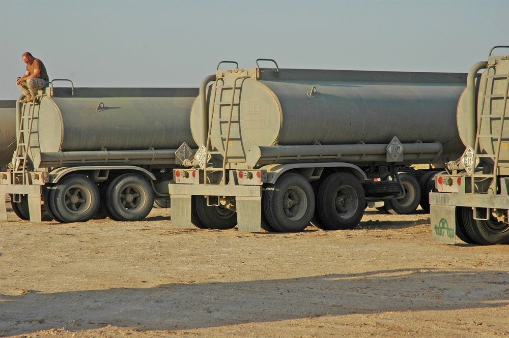 A driver quietly prepares himself before convoying tankers