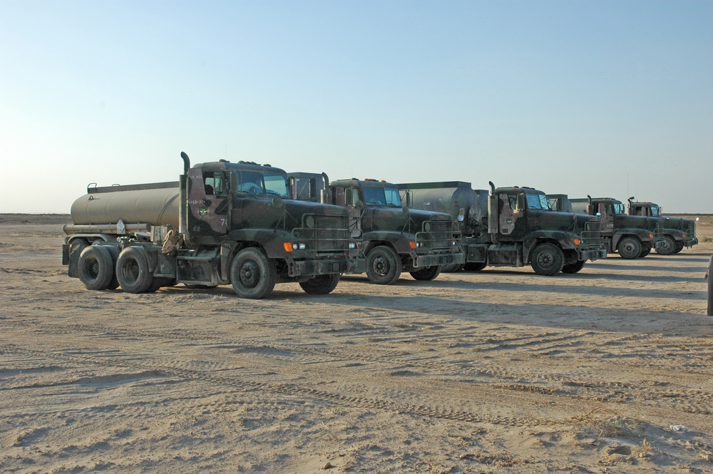 Drivers convoy tankers of fuel between Camps Taqqadum