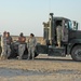 Soldiers talk amongst themselves before convoying tankers