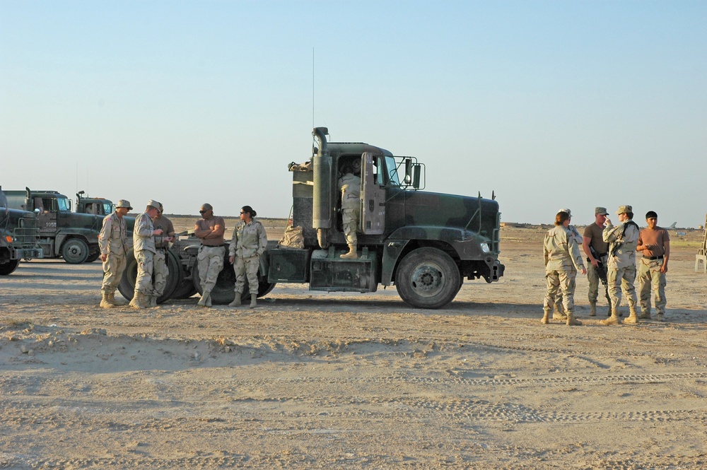 Soldiers talk amongst themselves before convoying tankers