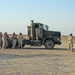 Soldiers talk amongst themselves before convoying tankers