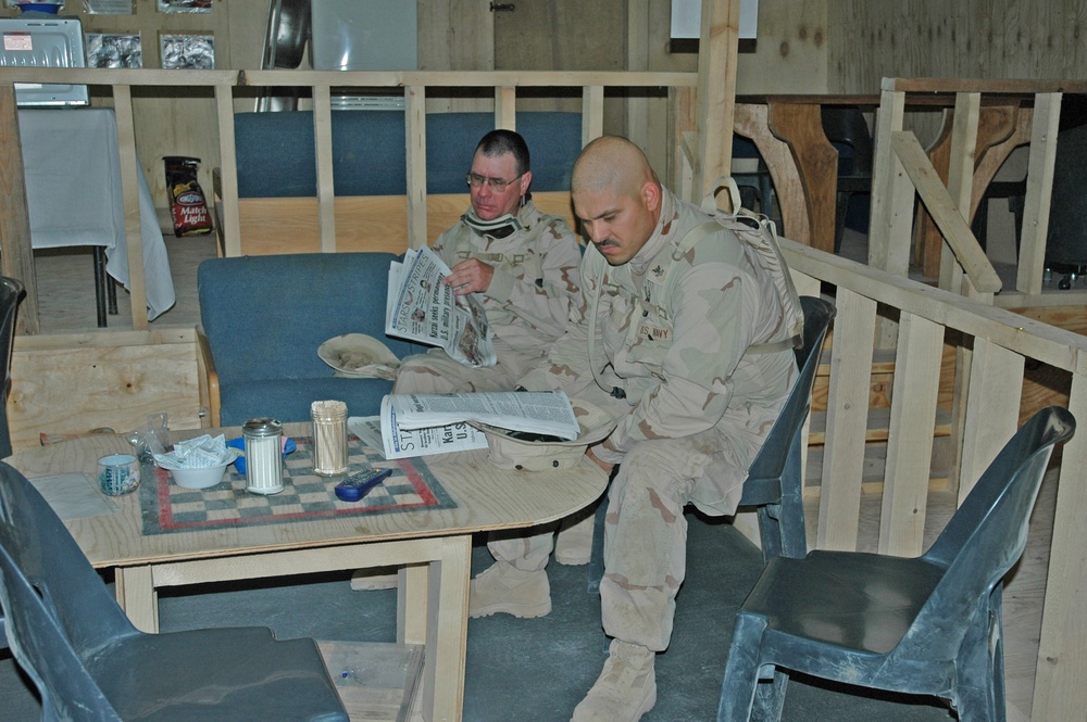 Sailors read newspapers at the Black Sheep Coffee House