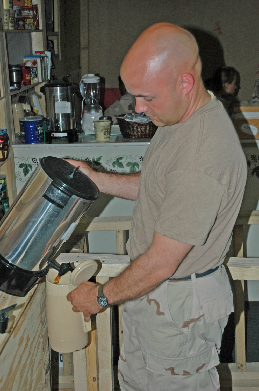 SFC Rick Weiss pours out old coffee