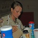 Spc. Emily Wiest pours a cup of coffee for a customer