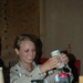 Spc. Wiest pours flavored syrup into a batch of coffee