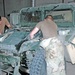 Two mechanics work on a M998 Humvee
