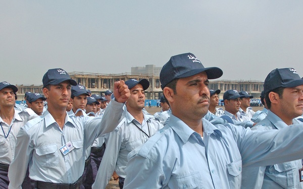 As an Iraqi Police Band plays, 930 IPs march past