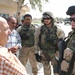 Soldiers speak with an operator of a water treatment facility