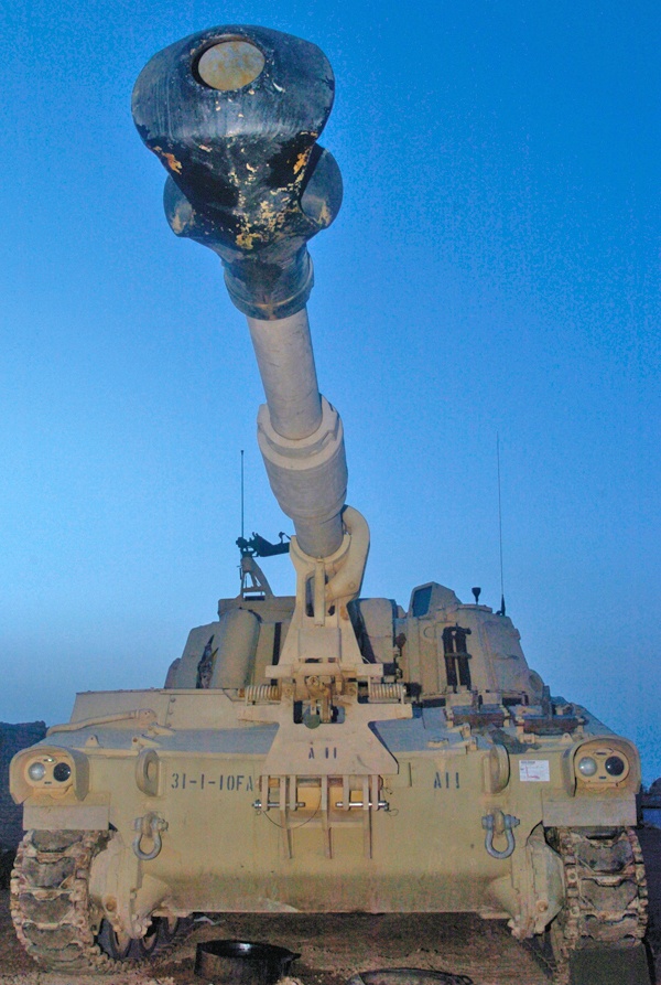 A 155mm Paladin howitzer stands ready for a fire mission