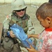Soldier passes out school supplies